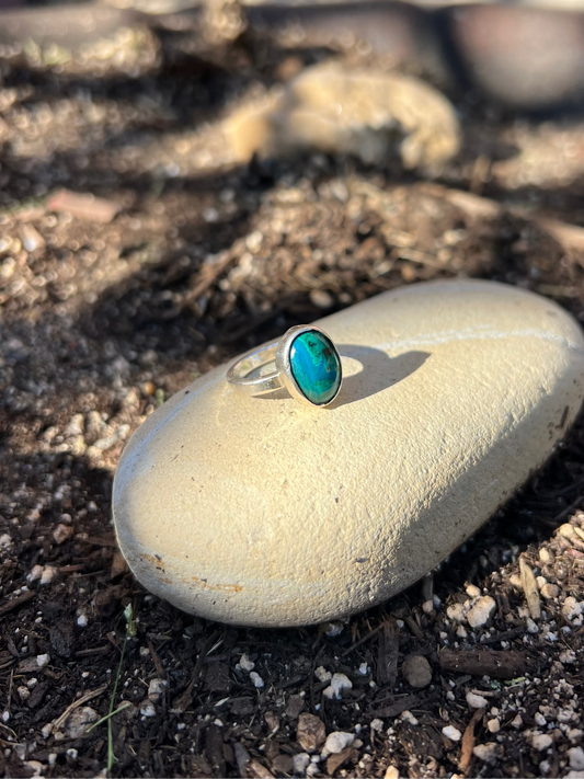 Turquoise ring on a rock with a natural outdoor background