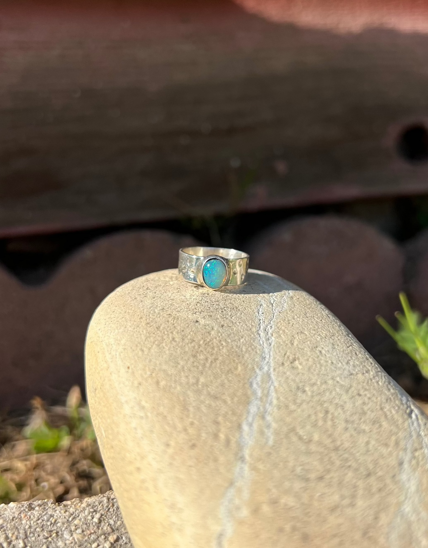 Silver ring with a turquoise stone on a rock