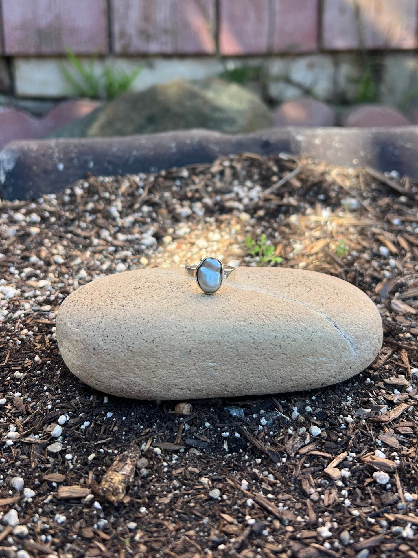 mint green baroque pearl ring on a rock