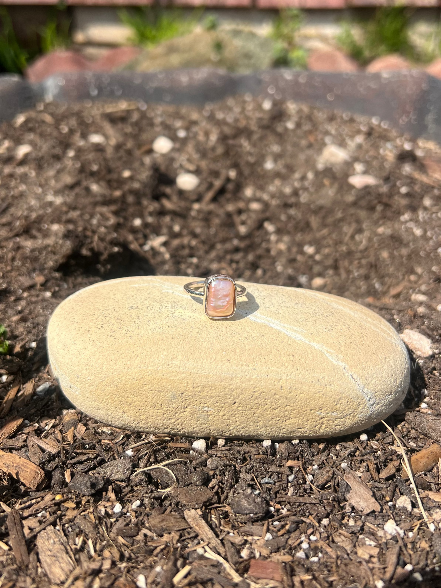 square pearl ring on a rock