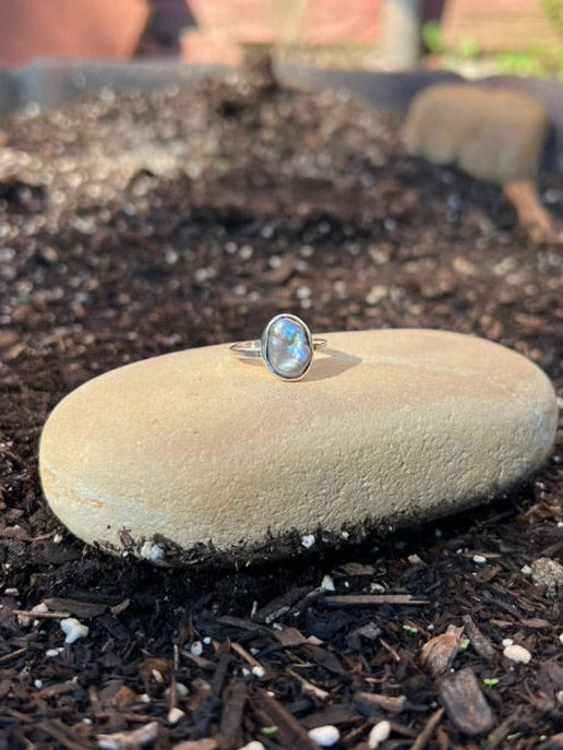 Ring on a stone in a garden bed with a blurred background