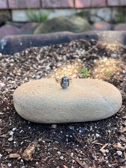Dainty Iridescent Baroque Pearl Ring on a rock