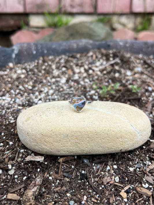 Heart-shaped ring on a stone with a blurred background