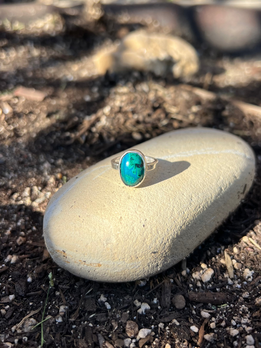 chrysocolla sterling silver ring on a rock in nature