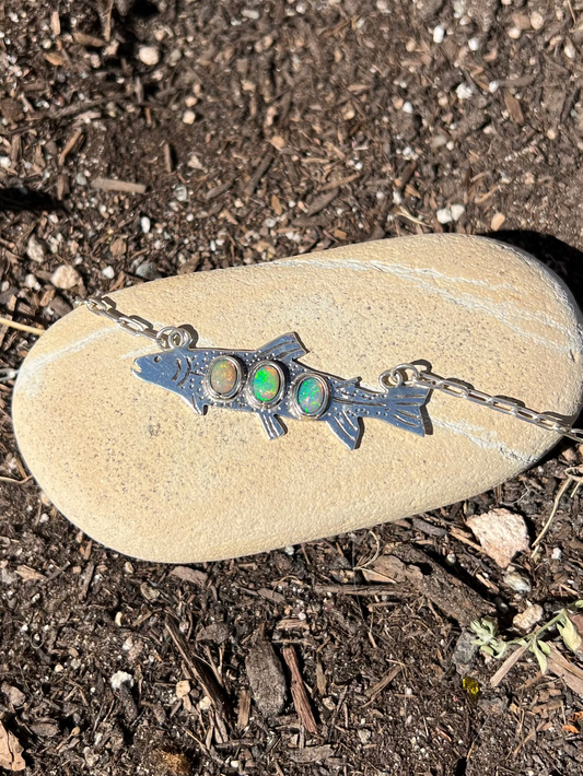 Necklace with a pendant on a rock in a natural setting