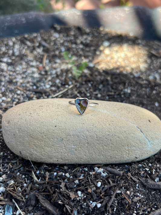 Heart-shaped ring on a stone in a garden setting
