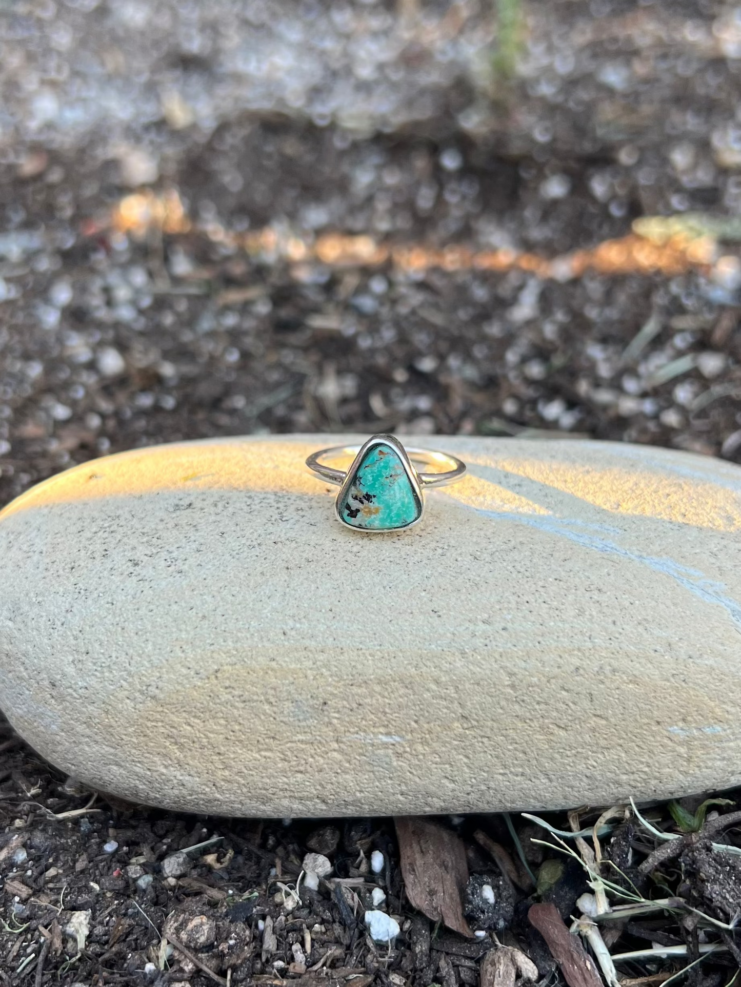 turquoise Ring on a stone in a garden setting